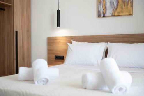 a bedroom with two beds with white pillows at Chryselia Suites- Private Pool in Keratokampos