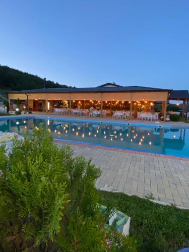 a pool at night with lights in a resort at Complex Praga in Gorno Lakočerej