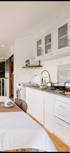 a kitchen with white cabinets and a sink at Grand view @lamaibeach in Koh Samui 
