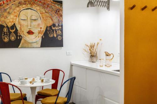 a dining room with a table and a painting on the wall at Di Grazia Cagliari - Stile, comfort e storia in Cagliari