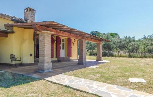 ein Haus mit einer Veranda mit einem Stuhl im Hof in der Unterkunft Ferienhaus mit Privatpool für 7 Personen ca 100 m in Monteverdi Marittimo, Toskana Etruskische Küste in Monteverdi Marittimo