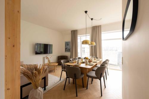 a dining room and living room with a table and chairs at Stunning Premium Apartment with Private Rooftop in Copenhagen