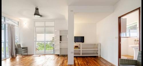 an open living room with white walls and wooden floors at Grand view @lamaibeach in Koh Samui 