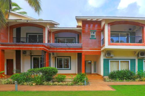 a large house with red brick at Royale Holiday Villa - 4BHK JAQK Holidays in Baga