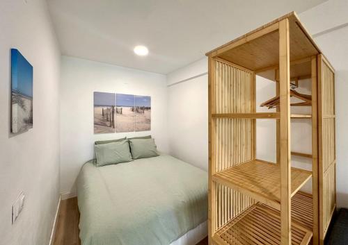 a small bedroom with a bed and a book shelf at Home Formentor Salou in Salou