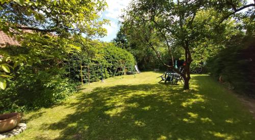 a yard with a tree and a playground at Wohnung In Jameln Mit Garten, Grill Und Terrasse in Jameln