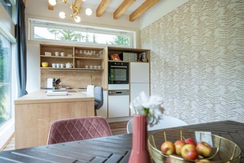 a kitchen with a table with a bowl of apples at Ferienwohnung Haus Melita In Feistritz Ob Bleiburg in Feistritz ob Bleiburg