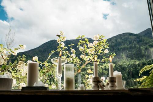 a group of candles sitting on a window sill with mountains at Ferienwohnung Haus Melita In Feistritz Ob Bleiburg in Feistritz ob Bleiburg