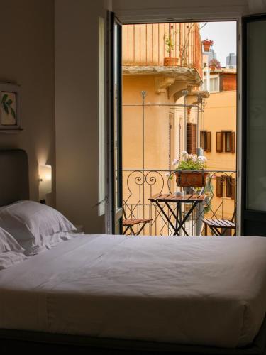 a bedroom with a bed and a view of a balcony at San Domenico Residence by BADIA NUOVA in Trapani