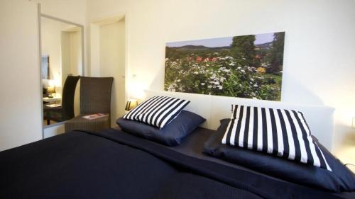 a bedroom with a bed with two pillows on it at Helle Und Moderne Ferienwohnung Mit Eigener Terrasse in Callenberg