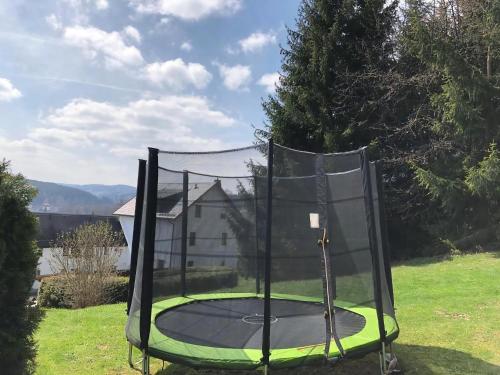 a trampoline in a yard with a net at Fewo Siebert in Bad Brambach