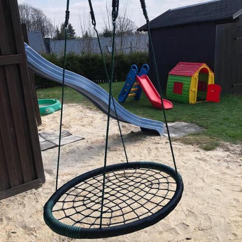 a swing set in a backyard with a playground at Fewo Siebert in Bad Brambach