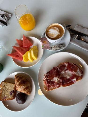 a table with three plates of food and a cup of coffee at Hotel & Thalasso Villa Antilla - Habitaciones con Terraza - Thalasso incluida in Orio