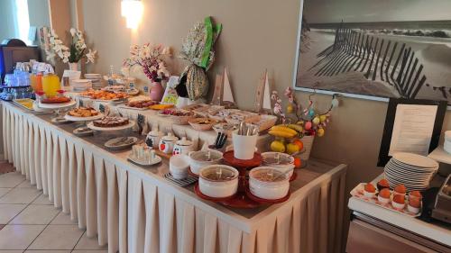 a buffet line with food and desserts on it at Hotel Capri in Grado