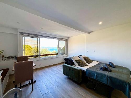 une chambre avec un lit et une grande fenêtre dans l'établissement Casamea - Studio vue mer, 2 min plage, Clim, à Ajaccio