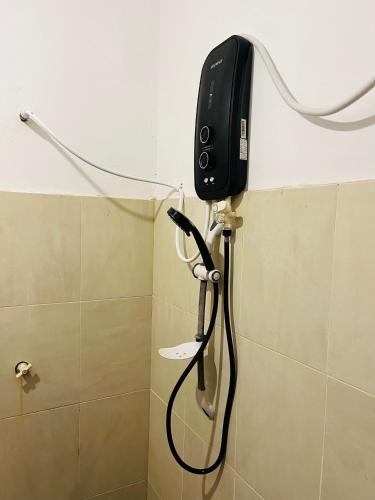 a telephone is hanging on the wall of a bathroom at Funky Leopard Safari Lodge Bordering Yala National Park in Kataragama