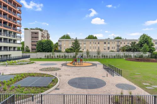 a park with a playground in front of a building at Cefalonia Garden with Terrace & Garage by NDP rent in Milan