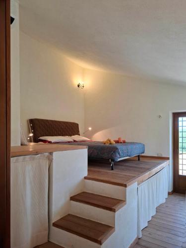 a room with a bed on top of a table at IL CASALE DEGLI ULIVI- Splendido casale panoramico con piscina a 30 min da Roma GRA in Calvi dellʼ Umbria