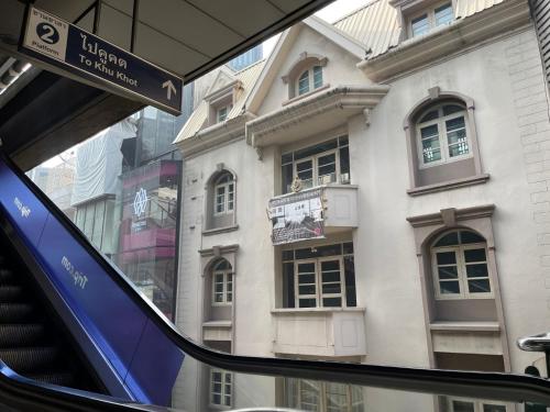 a view of a building from inside a bus at 24 Inn at BTS Phrom Phong in Bangkok