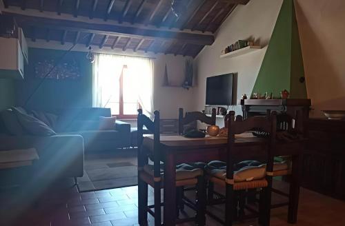 a kitchen and dining room with a table and chairs at Appartamento caratteristico su borgo "da Leone" in Castiglion Fosco