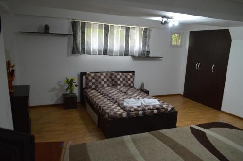a bedroom with a bed in the corner of a room at Csikos Apartment in Cluj-Napoca