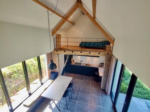 a view of the living room from the loft of a house at Nachtegael Poorthuis. Een ruime, lichte woning in loft stijl. in Kluisbergen