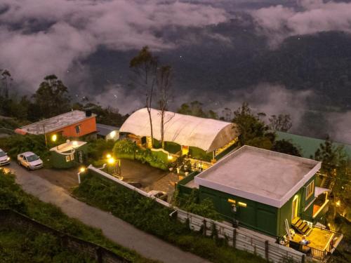 an aerial view of a house with a tent at The Hosteller Munnar in Munnar