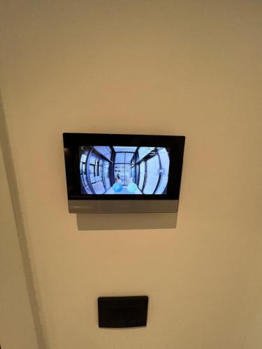 a flat screen tv hanging on a wall at BW Simfonia Apartman 407-whit free garage parking in Belgrade