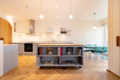 a kitchen with a counter with books on it at Mews House South Ken in London