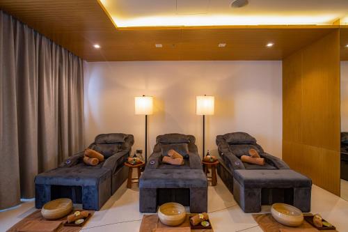 two chairs and a table in a room at TMS Hotel Da Nang Beach in Da Nang