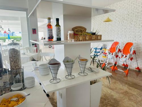 a room with chairs and vases on a shelf at Napa Jay Hotel in Ayia Napa