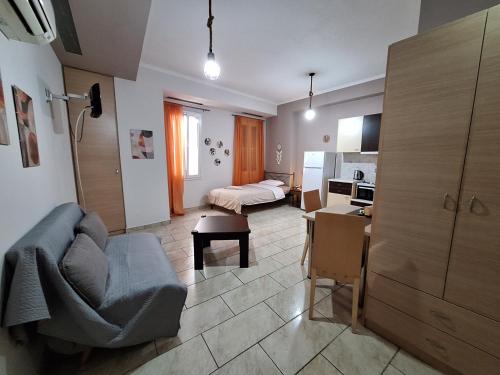 a living room with a couch and a kitchen at KAMPANI STUDIO in Chios