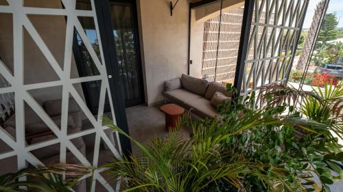 a living room with a couch on a balcony at Terreforti Luxury Village in Agrigento