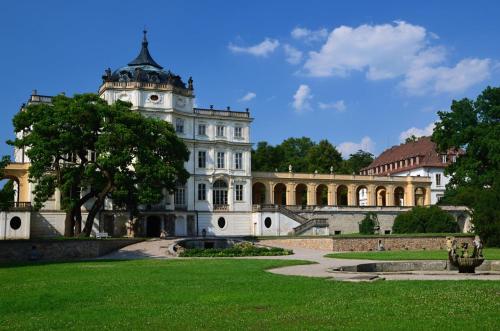 a large white building with a tree in front of it at Chaloupka u Lovoše in Velemín