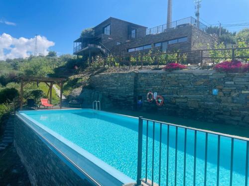 a swimming pool in front of a building at Quinta do Casal Bystol - Casa 2 in Casal de Loivos