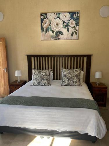 a bedroom with a large bed with two pillows at Kaoko Bush Lodge in Kamanjab