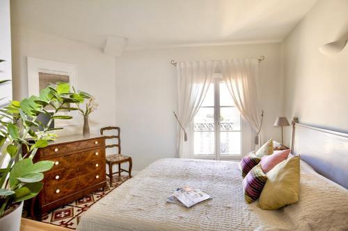 a bedroom with a bed with a dresser and a window at Cinq & Sept LGBT Resort for men in Roujan