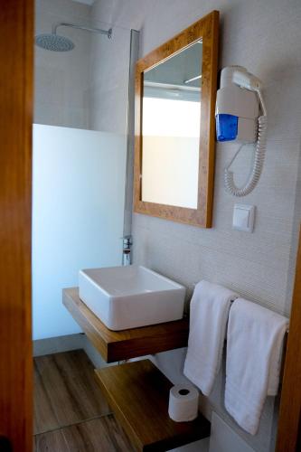 a bathroom with a white sink and a mirror at Montinho De Ouro in Luz