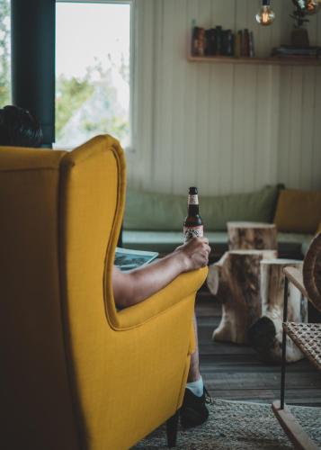 a person sitting in a chair holding a beer bottle at Zwier, de Vrijhaven in Vinkeveen