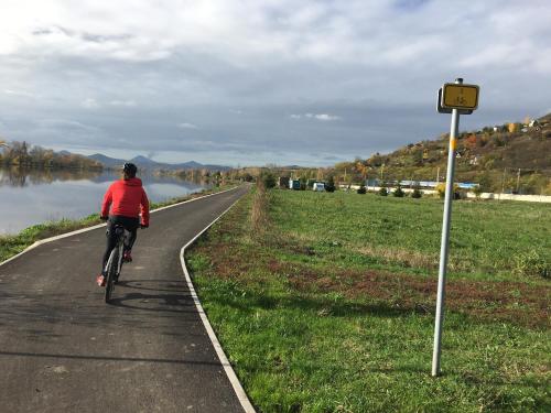 a person riding a bike on a path next to a river at Chaloupka u Lovoše in Velemín
