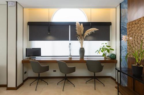 a kitchen with a bar with chairs and a window at Microtel by Wyndham General Santos in General Santos