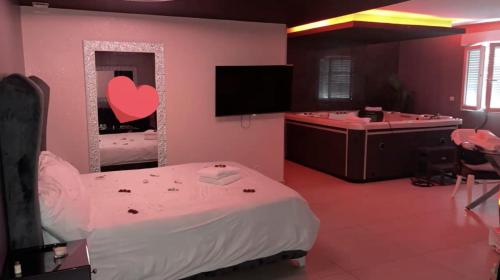 - une chambre avec un lit, un miroir et une baignoire dans l'établissement Love Paradise, à Le Rove