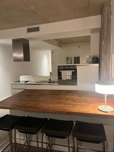 a kitchen with a counter with four stools at F 02 Loft in Montréal