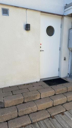 a white door on the side of a house at Villa South Beach in Karlskrona