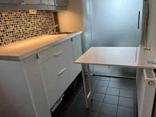 a white kitchen with a sink and a counter at Villa South Beach in Karlskrona