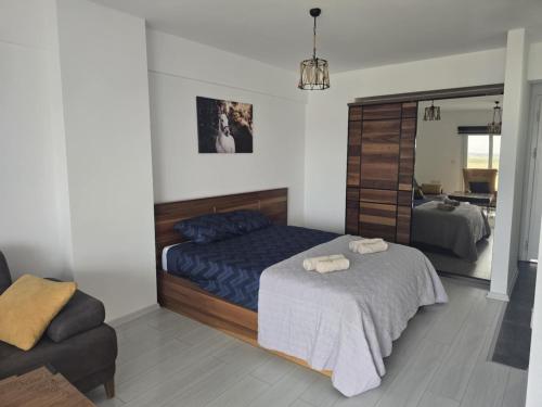 a bedroom with a bed and a mirror at Edelweiss Resort Luxury Studio Apartment in Iskele
