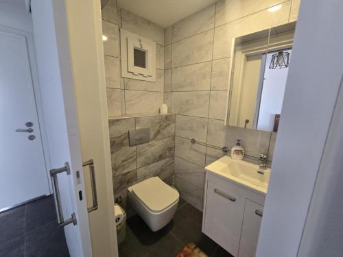 a bathroom with a toilet and a sink at Edelweiss Resort Luxury Studio Apartment in Iskele