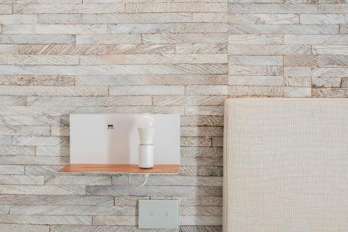 a vase on a shelf on a brick wall at Noto Boutique Hotel in Noto
