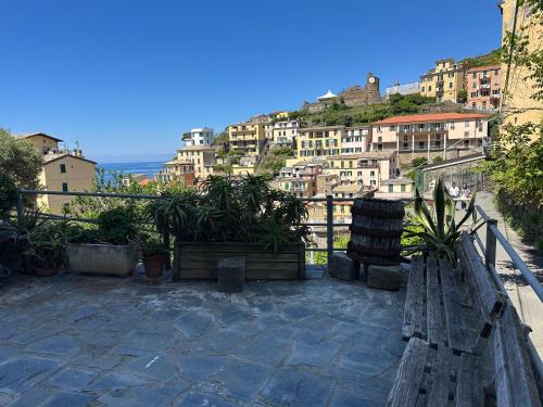 a bench in front of a city with buildings at La Vista Panoramica in Riomaggiore