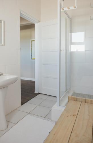 a bathroom with a shower and a sink at Seal Point Lighthouse in Cape St Francis